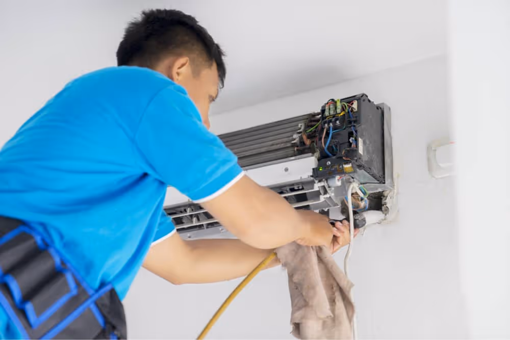 man performing ac maintenance